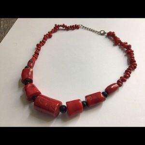 Chunky red and black plastic bead necklace.